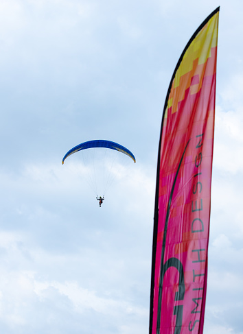 Paragliding sport, flying against the blue sky in An Giang province, Mekong Delta