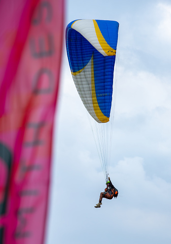 Paragliding sport, flying against the blue sky in An Giang province, Mekong Delta