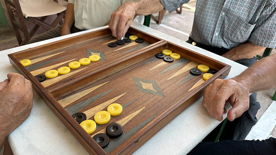 old people playing backgammon