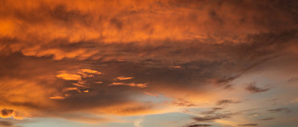 istock Dense orange clouds in the sky at sunrise 1753541546