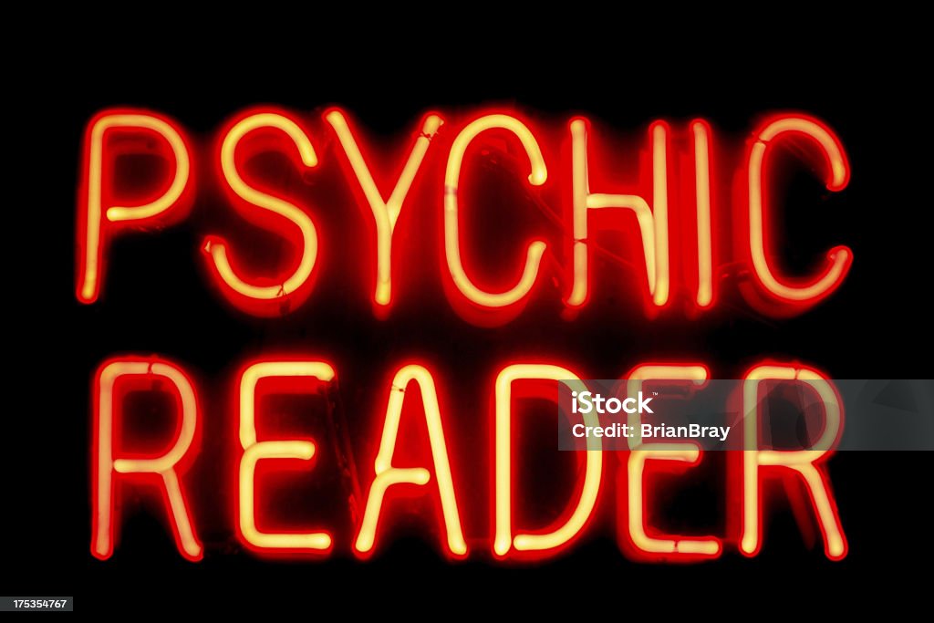 Neon sign, psychic reader Real neon sign advertising a psychic and palmistry business, on black background. Fortune Telling Stock Photo