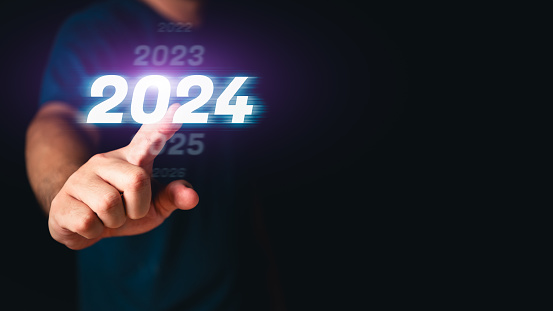 Man hand touching the 2024 abstract cyberpunk technology interface by pointing finger on isolated black background with copy space. Happy New Year 2023 to 2024 concept. Innovation and hitech theme.