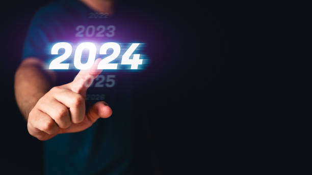 Man hand touching the 2024 abstract cyberpunk technology interface by pointing finger on isolated black background with copy space. Happy New Year 2023 to 2024 concept. Innovation and hitech theme. stock photo