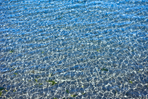 High angle view of seawater surface texture background of the shallow sea.