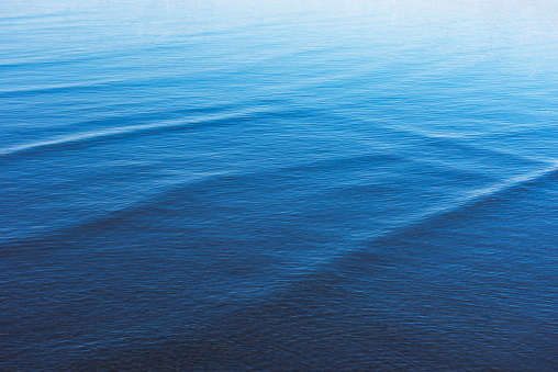 High angle view of seawater surface texture background of the shallow sea.