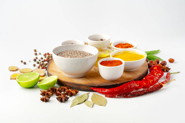istock Bowls with spices on wooden board on white background 1753574301