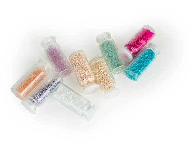istock multi-colored beads in round tubes and jars 1753579550
