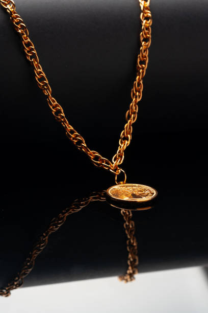 istock Golden chain necklace on black background with reflection 1753580064