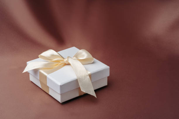istock White jewelry boxes on brown silk background 1753593517
