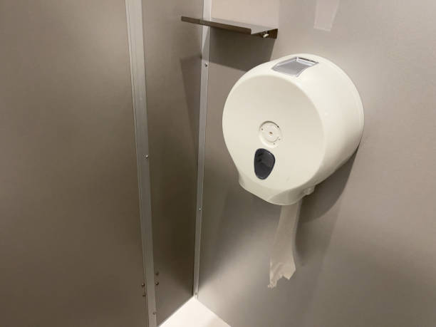 istock Toilet paper holder on a gray wall in a modern restroom. 1753615784