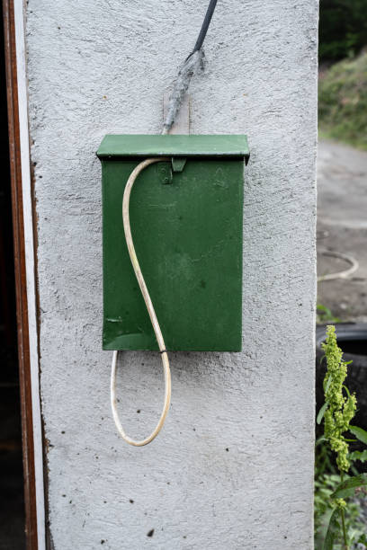 istock Green post box with a mysterious hos sticking out of it.. 1753617827