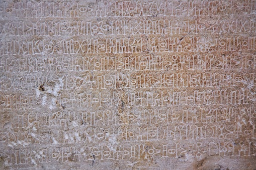 Ancient inscriptions on stone, close-up. Historical research and archaeology.