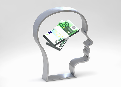 Silhouette of a human head with turning money on his mind. / You can see the animation movie of this image from my iStock video portfolio. Video number: 1746249170