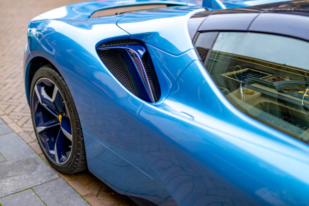 Ferrari SF90 sports car in light blue parked on the street in Zwolle. The Ferrari SF90 Stradale, unveiled in 2019, is a hybrid sports car and the first series-production Plug-In Hybrid Electric Vehicle (PHEV) from Ferrari. The SF90 Stradale is powered by a 4.0-liter twin-turbocharged V8 engine coupled with three electric motors – two at the front and one at the rear.