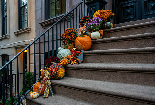 Colorful Pumpkins and Halloween decorations on the Stairs of an Old Brownstone Home in Upper East side, New York City