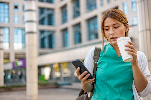 istock Caucasian female nurse is scrolling on her smartphone. 1753678631
