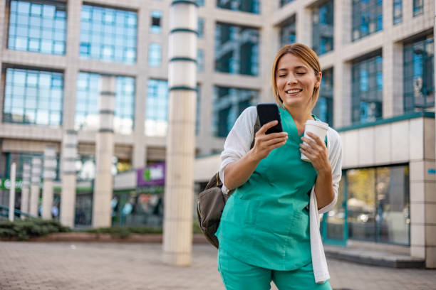 istock Nurse standing outside to take a break and read an article on her phone. 1753678640