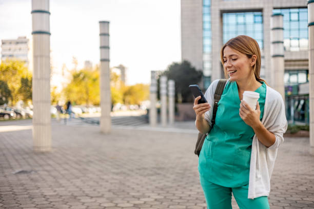istock Female doctor typing on the smart phone outdoors. 1753678646