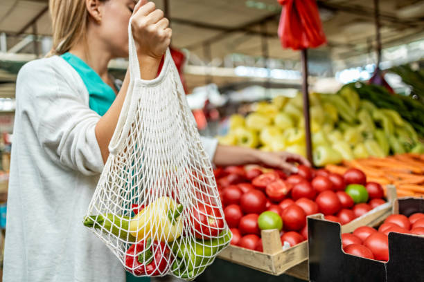 istock Female shopper buying at a local grocery store using a reusable bag 1753679164