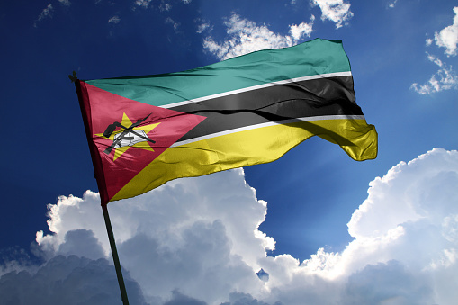3d illustration flag of Mozambique. Mozambique flag isolated on the blue sky with clipping path.