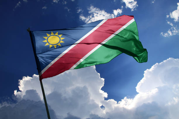 national flag of Namibia waving in the wind on a clear day. 3d illustration flag of Namibia. Namibia flag isolated on the blue sky with clipping path. flag of namibia stock pictures, royalty-free photos & images