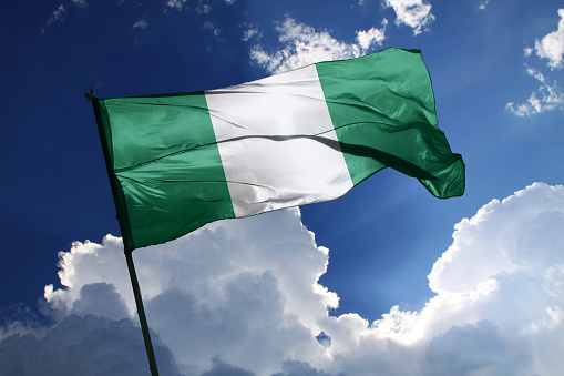 3d illustration flag of Nigeria. Nigeria flag isolated on the blue sky with clipping path.