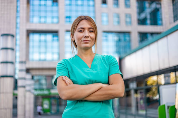 Smiling female healthcare worker with arms crossed