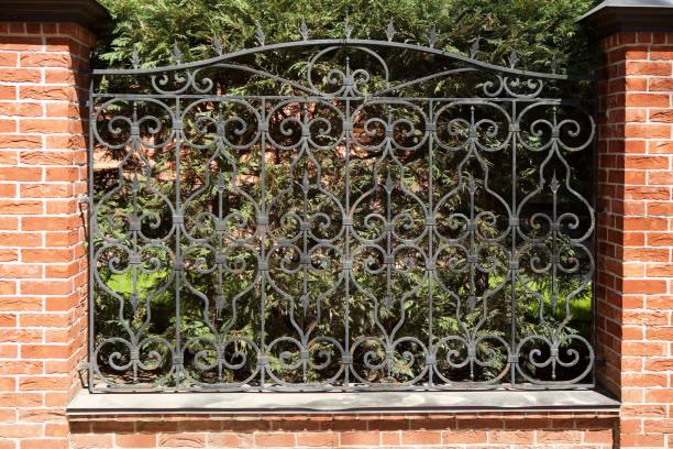 istock Forged metal fence with brick pillars. 1753691470