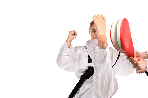 Martial artist using a front kick on a focus pad.