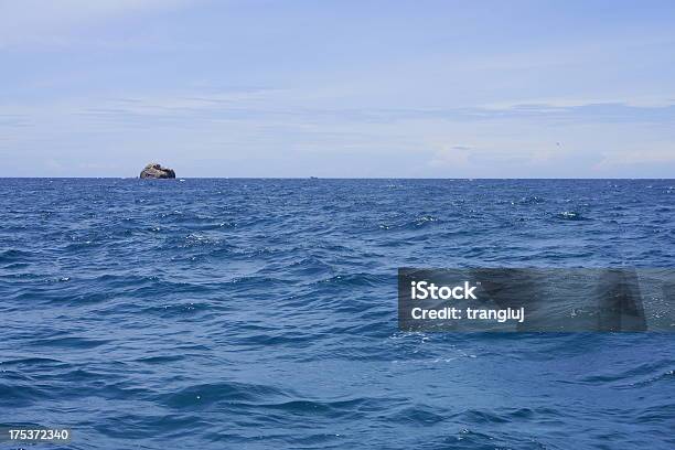 Solo Rock On Blue The Sea Stock Photo - Download Image Now - Blue, Horizon, Horizon Over Land