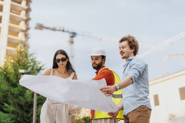 istock Corporate Architects Discussing Blueprint and Project Costs at Workplace 1753727851