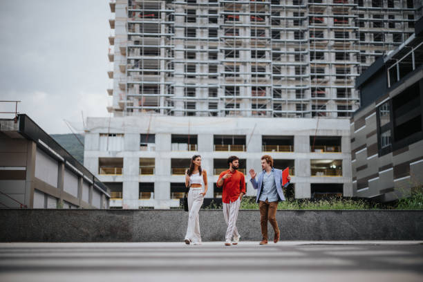 istock Architects, designers, and engineers discuss project details at a building exterior, showcasing successful teamwork and sustainable design. 1753729394