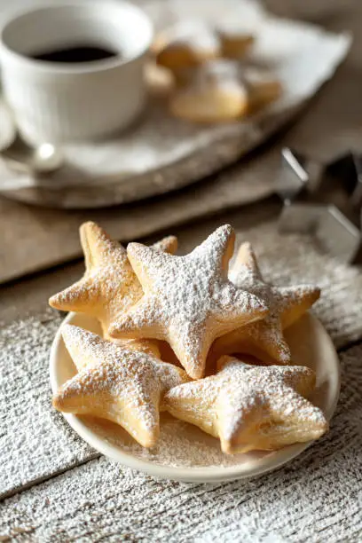 Star shaped puff pastry snack, afternoon tea sweet treats served on wooden table