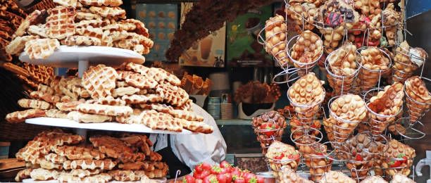 istock A lot of Freshly made belgian waffles sprinkled powdered sugar. 1753750919