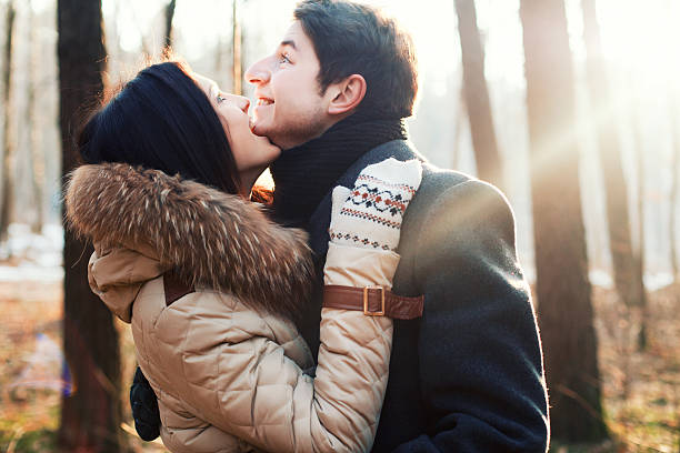 Happy Young Couple in Autumn Park having fun stock photo