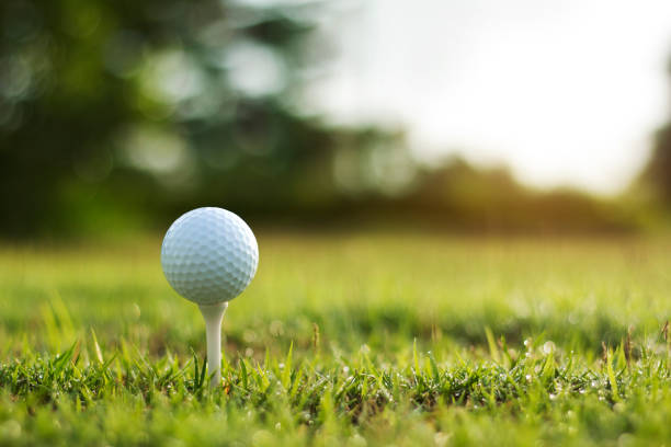istock golf ball on tee in a beautiful golf course with morning sunshine 1753762607