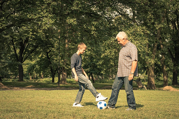 istock Grandfather and grandson playing in the park 175376511