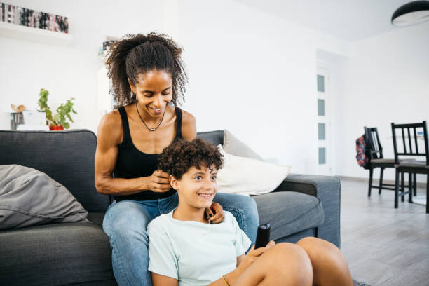 istock Mother and her daughter sitting on sofa 1753765319