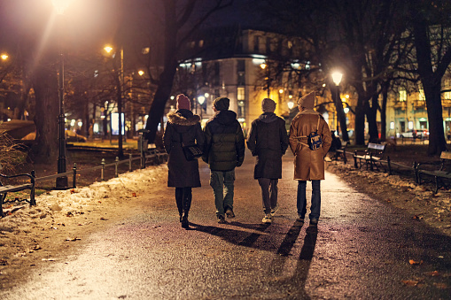 Mother and teenagers enjoying walking In Krakow, Poland. Winter evening on Christmas day
They are walking in the Planty public park.
Shot with Canon R5