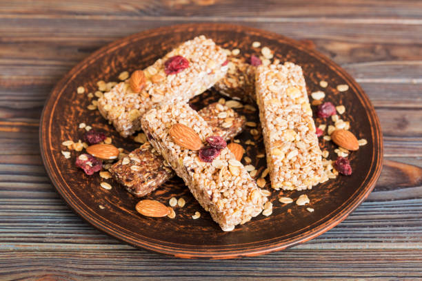 istock Various granola bars on table background. Cereal granola bars. Superfood breakfast bars with oats, nuts and berries, close up. Superfood concept 1753775605