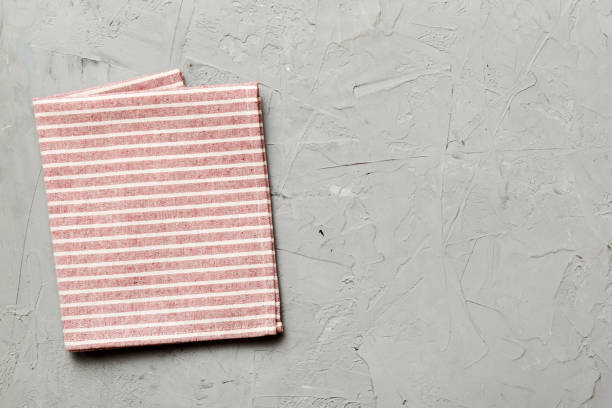 istock top view with red empty kitchen napkin isolated on table background. Folded cloth for mockup with copy space, Flat lay. Minimal style 1753775728