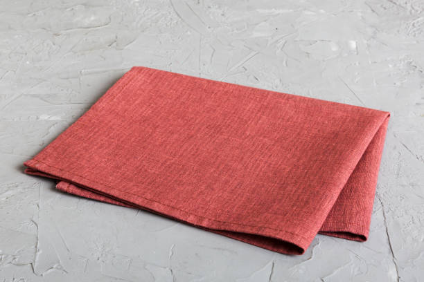 istock top view with red empty kitchen napkin isolated on table background. Folded cloth for mockup with copy space, Flat lay. Minimal style 1753776207