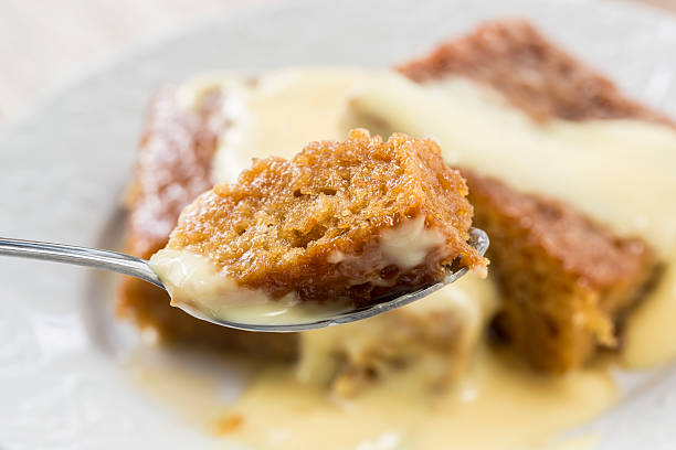 Spoonful of malva pudding Malva pudding. A South African dessert. Sponge cake with a caramelized butter sauce malva stock pictures, royalty-free photos & images