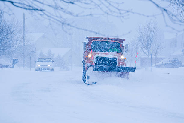 istock Heavy snowfall and a car behind the snowplow 175379766