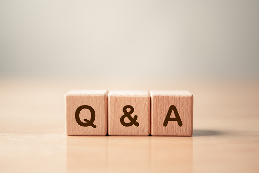 Question and Answer Q and A text on wooden block background. Business and communication concept.
