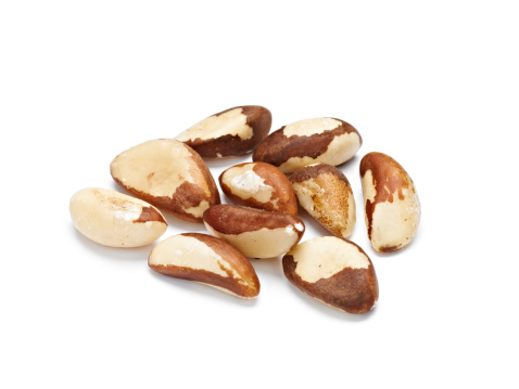 Raw Brazil Nuts on White Background.