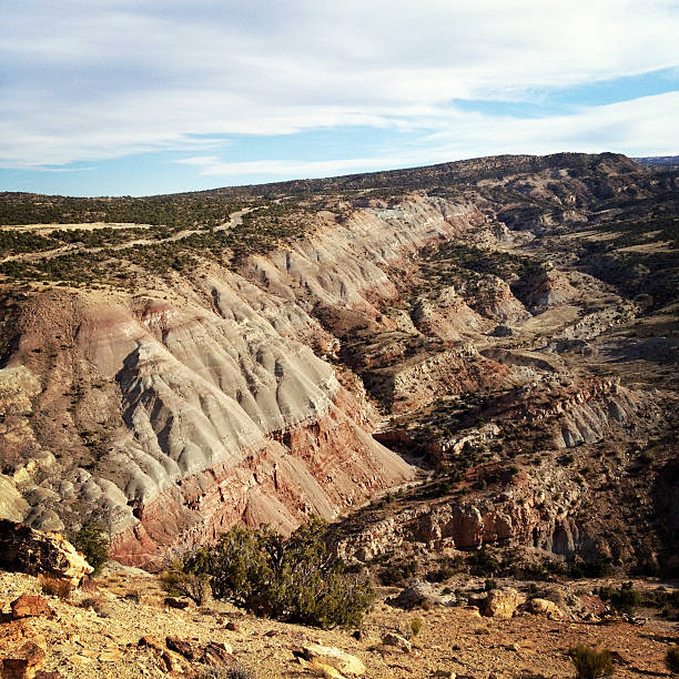 landscape desert badlands "landscape desert badlands make for dramatic and beautiful nature scenery.  square composition with muted retro color treatment taken in grand junction, colorado." sonoran desert desert badlands mesa stock pictures, royalty-free photos & images