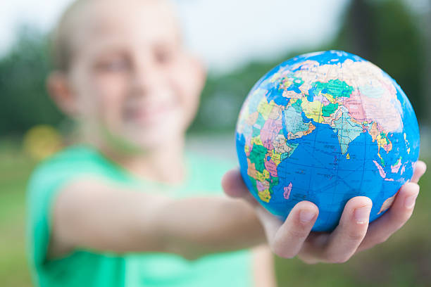 istock Selective focus; little girl holding globe to show environmental responsibility 175380663