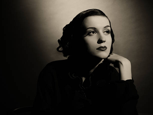 Film Noir style Female portrait Emulation of vintage style photography.Grain added for more film effect.See the Lightbox: femme fatale stock pictures, royalty-free photos & images