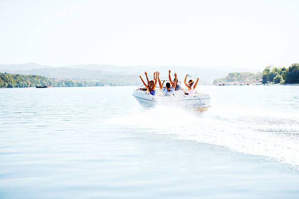 istock Cheerful young people riding in a speedboat. 175380956